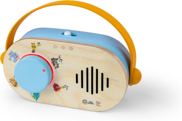 A close-up of the Baby Einstein + Hape Discovery Radio Toy, a small wooden radio with a dial and flexible strap.