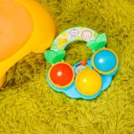 A Bright Starts Safari Beats musical drum toy featuring three colorful drums with lights, designed for babies aged 3 months a
