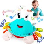 A cyan plush crab toy with large eyes and a friendly smile, shown in a crawling position with musical notes around it.