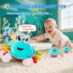 A cyan plush crab toy with large eyes and a friendly smile, shown in a crawling position with musical notes around it.