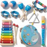 A blue fabric bag containing 14 wooden musical instruments, including a small xylophone, maracas, and tambourine.