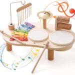 Promise Babe Wooden Drum Set for toddlers with xylophone, drums, cymbals, and wind chime on a wooden table.