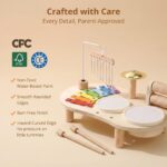 Promise Babe Wooden Drum Set for toddlers with xylophone, drums, cymbals, and wind chime on a wooden table.
