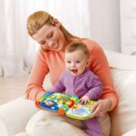 A red VTech Musical Rhymes Book, open to a colorful page with interactive elements and piano keys.
