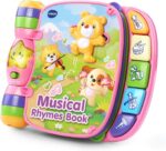A red VTech Musical Rhymes Book, open to a colorful page with interactive elements and piano keys.