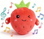 A soft pink strawberry plush toy with embroidered features, designed for sensory and musical play with babies and toddlers.