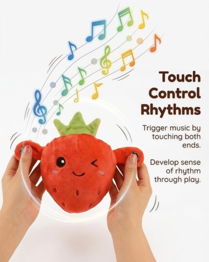 A soft pink strawberry plush toy with embroidered features, designed for sensory and musical play with babies and toddlers.
